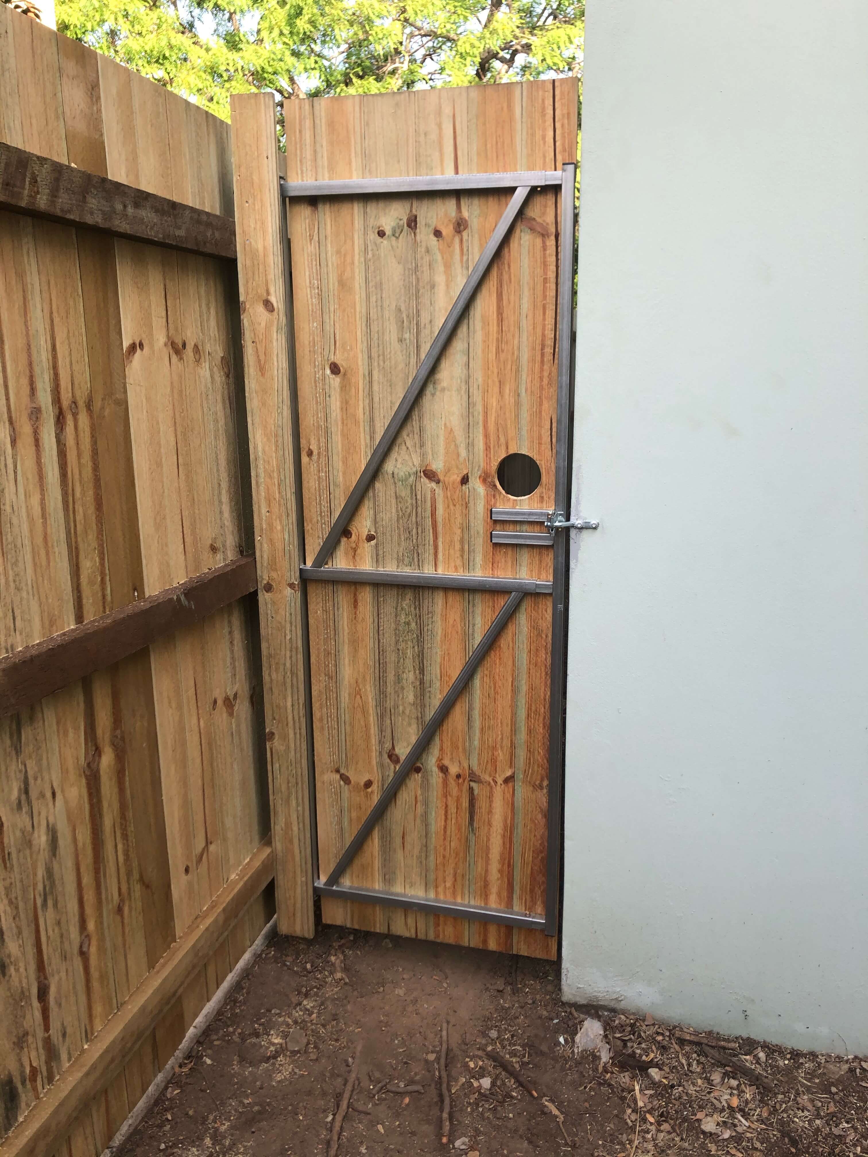 completed strata building maintenance in Brisbane view of new wooden side gate between fence and wall of strata complex