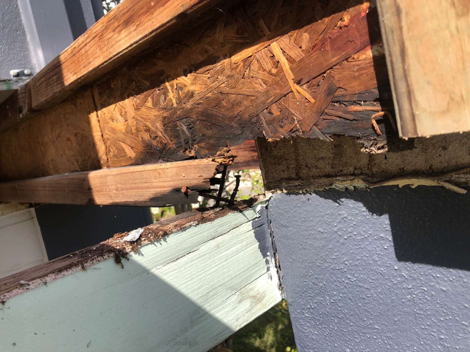 rotted structural timber before balcony repairs as part of building maintenance in Brisbane strata complex 