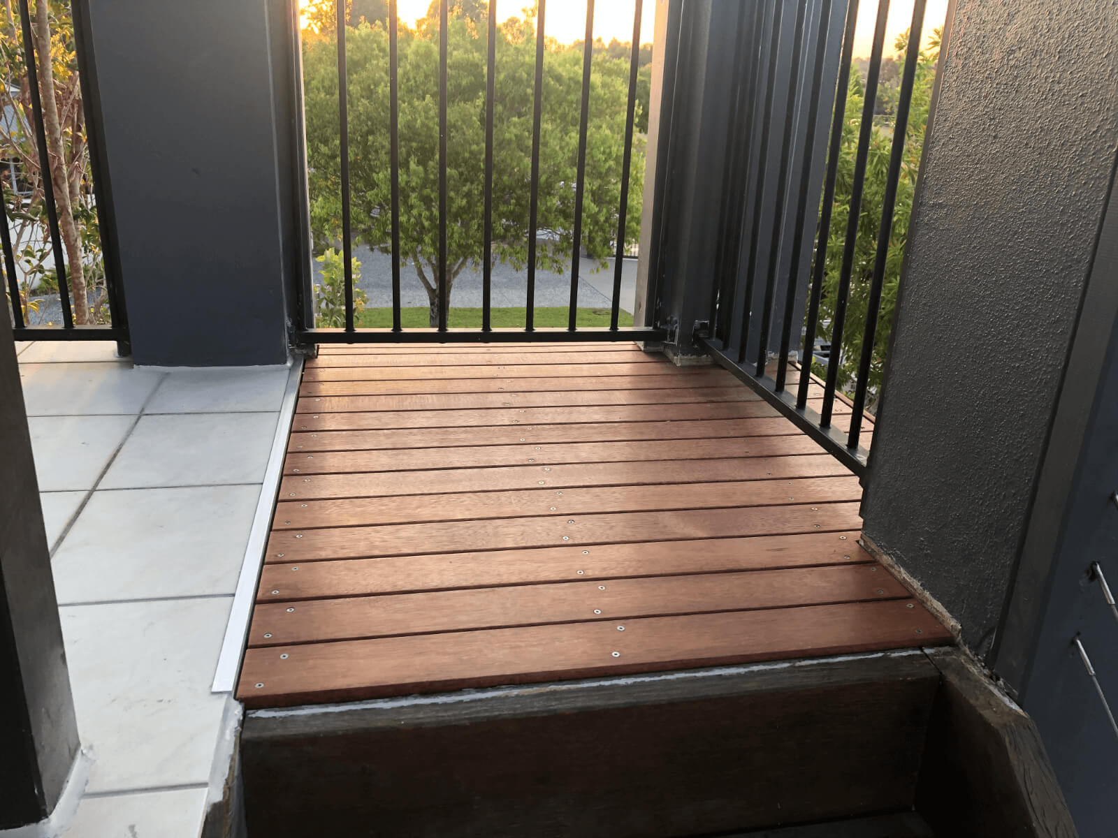 hardwood timber landing with black railings after building maintenance in Brisbane strata complex